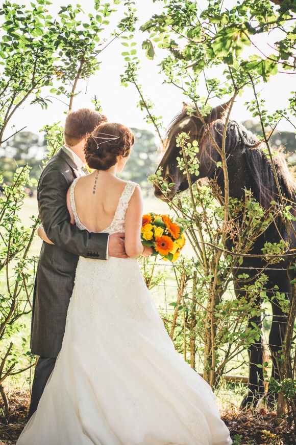bride with groom and a horse