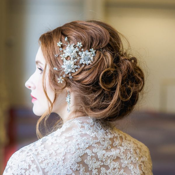 3 bridal pearl and crystal hairpins in a brides hair