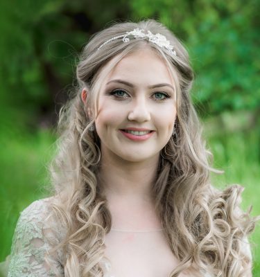 blush and crystal flower headpiece on blonde bride with long hair